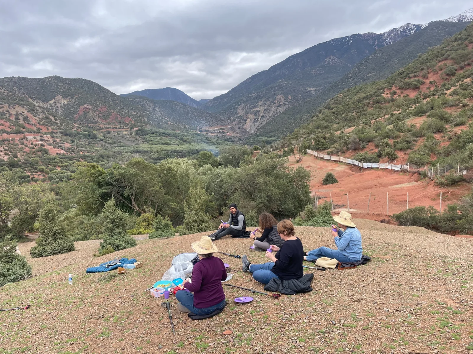 Sharing a picnic on a ridge above the Azaden valley, snowy peaks in the distance
