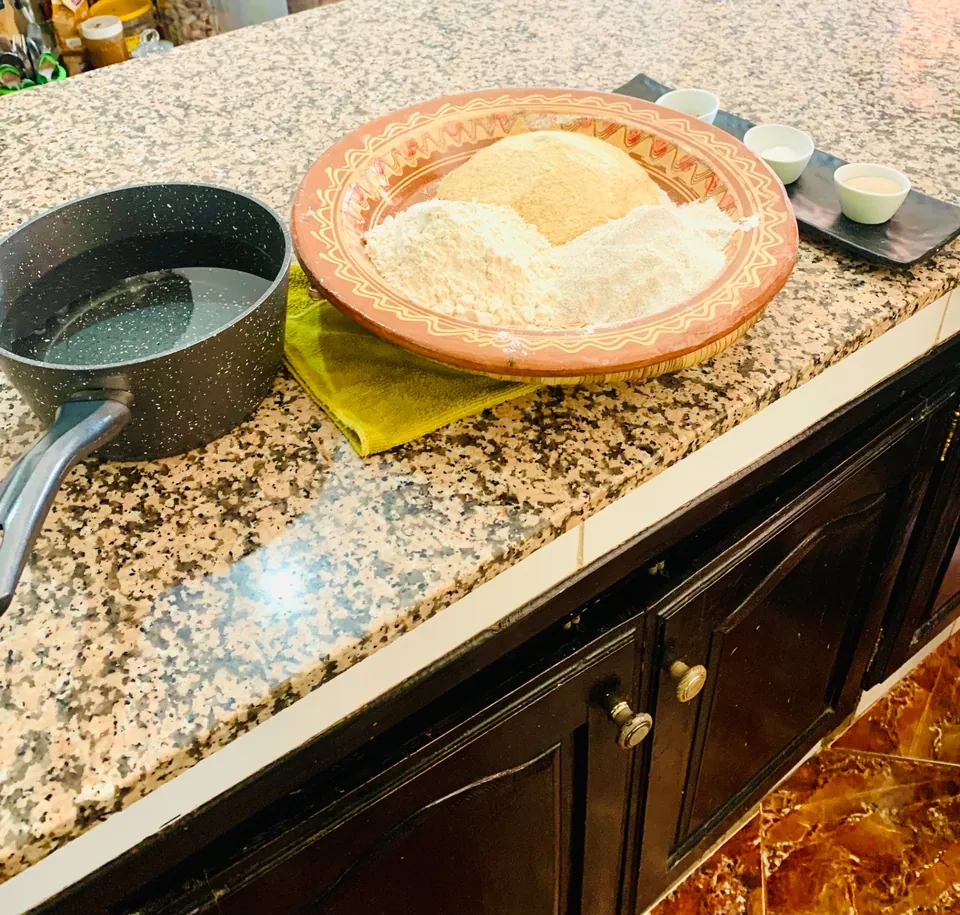 Barley, wheat and semolina flours weighed out by hand before kneading