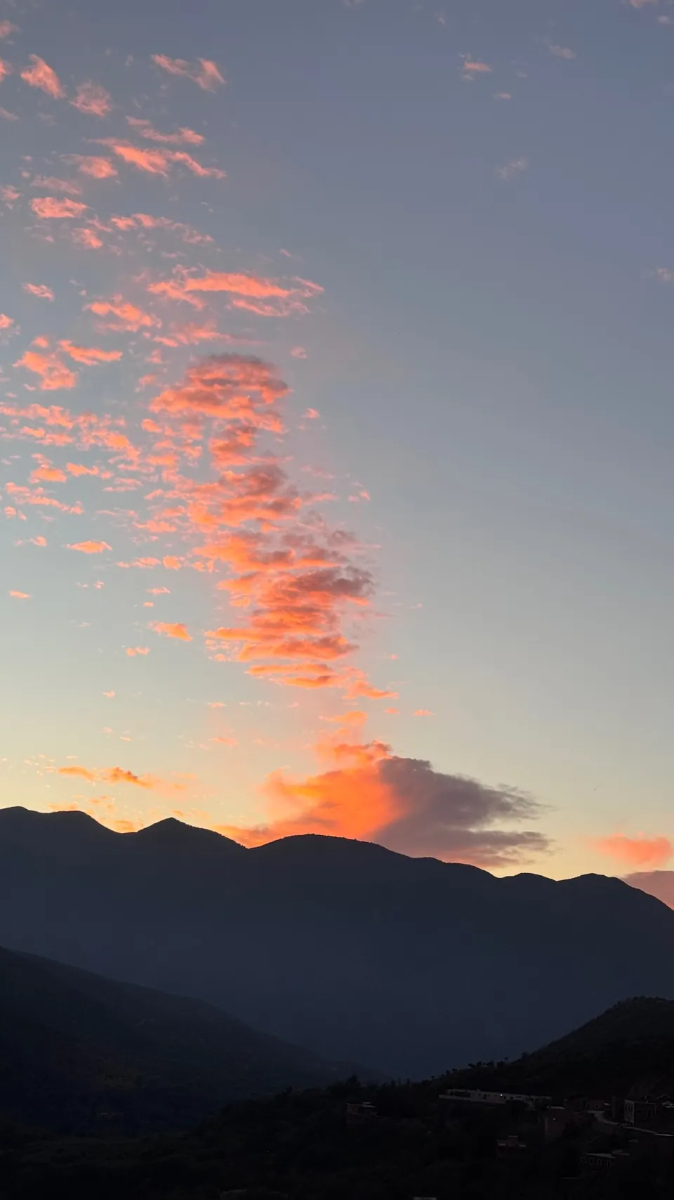 Pink clouds catching the last light above the Atlas ridges