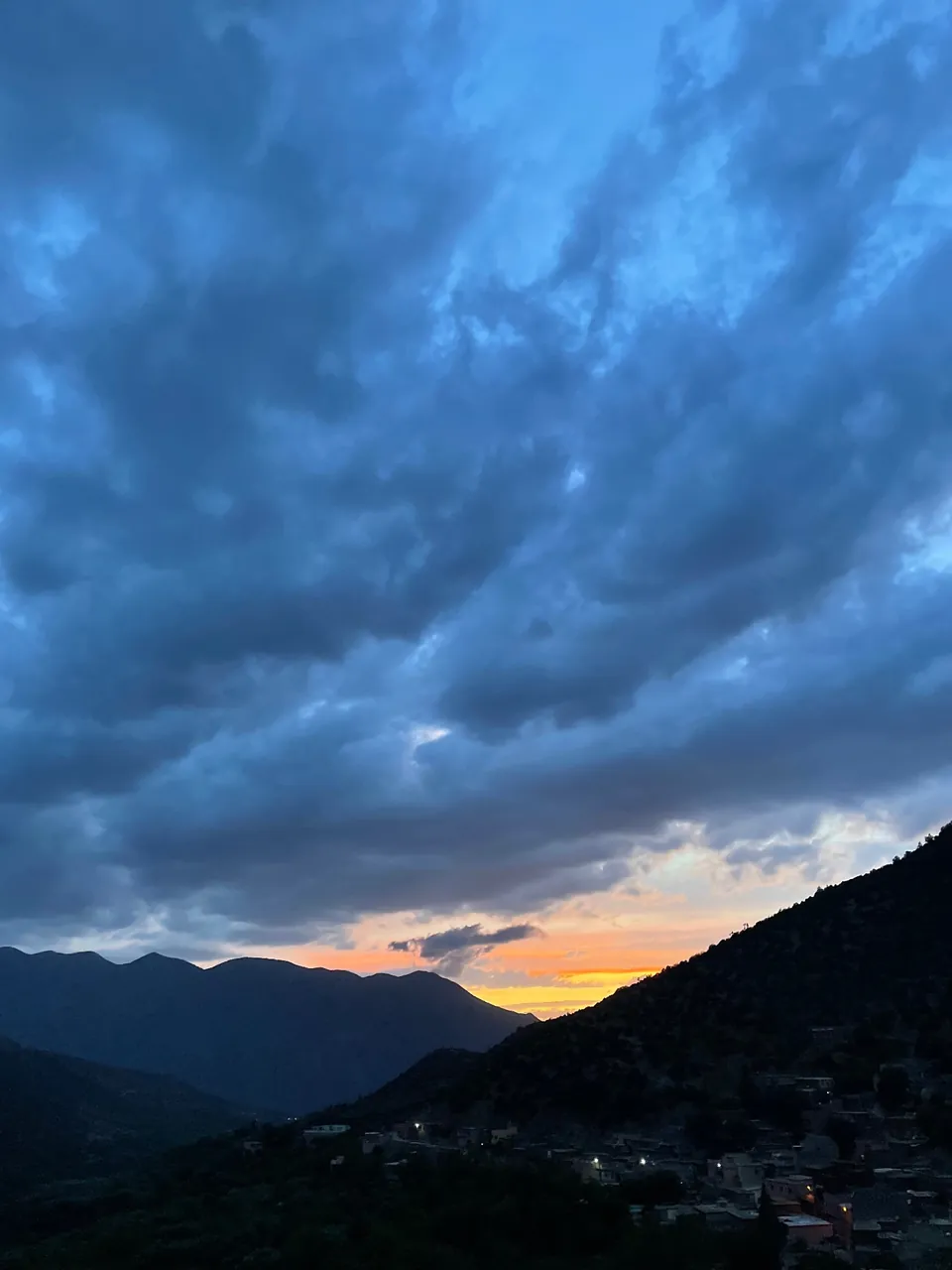 Sunset over the Azaden valley, the village lights coming on below the ridges